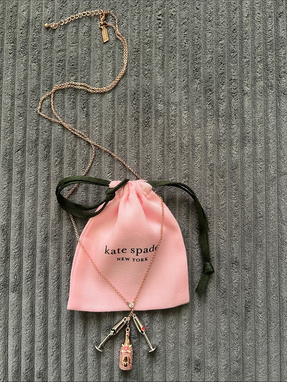 KATE SPADE Make Magic Rose Gold Champagne Bottle &
Glasses Necklace